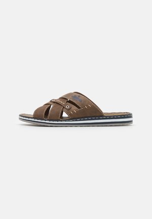 Brown leather sandal featuring a cross-strap design, contrasting stitching, and a white/blue striped sole for added detail and stability.