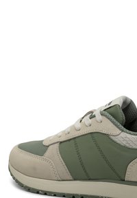 Green and beige sneaker with mesh and suede materials, round toe, white laces, and textured accents on the sides and heel.