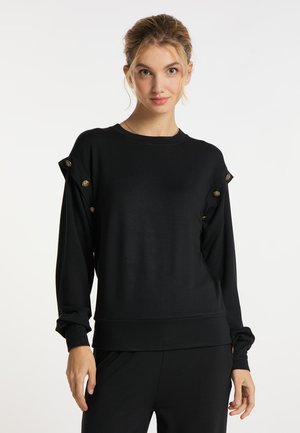 Zwarte sweatshirt gemaakt van zachte stof. Heeft een ronde hals, lange mouwen en decoratieve gouden knopen op de schoudernaden.