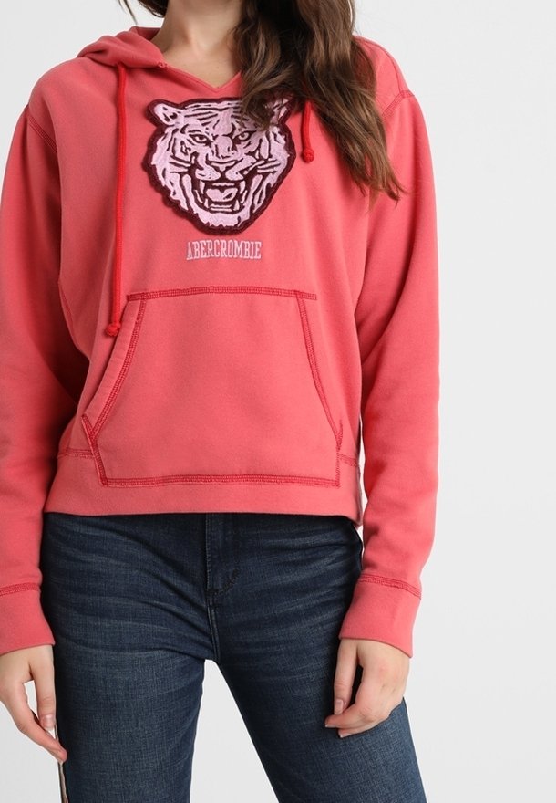 Roze cropped hoodie met een tijgerafbeelding en de tekst "Abercrombie"; heeft een voorkantzak, een capuchon met trekkoord en een zachte stofstructuur.