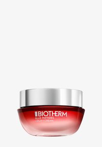 Biotherm Uplift Cream i en rund glasburk har en gradient röd design med ett silverlock. Etiketten visar produktnamn och varumärke.
