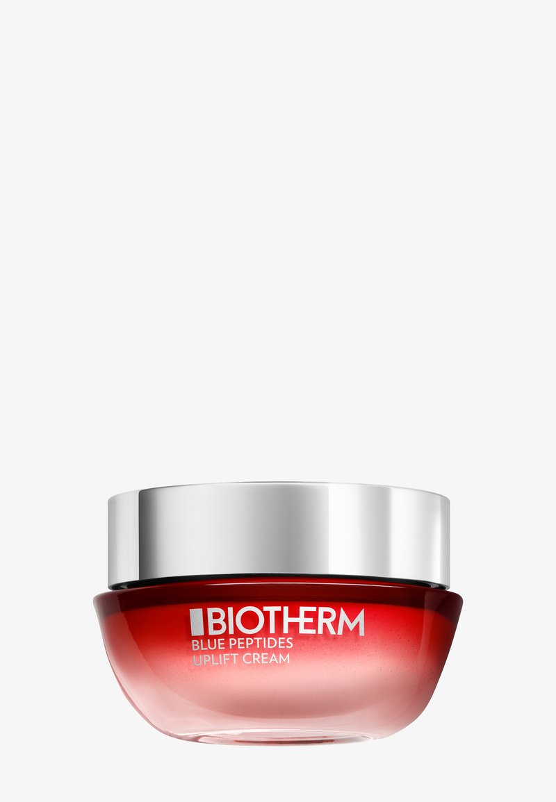 Biotherm Uplift Cream i en rund glasburk har en gradient röd design med ett silverlock. Etiketten visar produktnamn och varumärke.