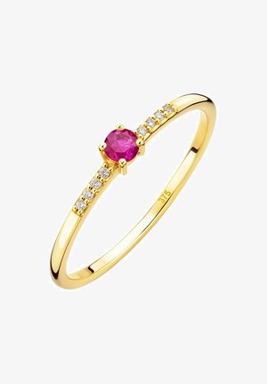 Gold ring featuring a central round pink gemstone set in a six-prong setting, adorned with small clear stones along the band.