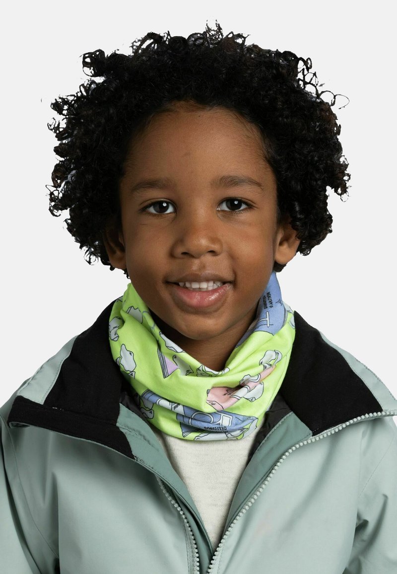 Multicolored neck gaiter with green base and playful patterns featuring animals and objects, worn under a light green jacket with a black collar.