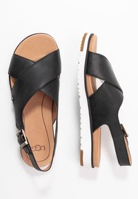 UGG Sandaalit nilkkaremmillä - black