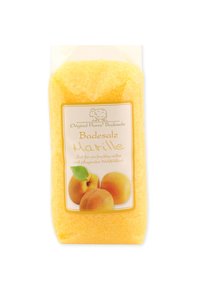 Yellow bath salt in a transparent package, featuring a label with apricot imagery and text, highlighting fruity and nurturing properties.
