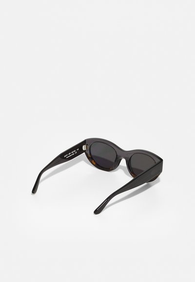 Black oversized sunglasses with rounded lenses and a matte finish. Tortoiseshell accents on the temples. Model number on the inner frame.