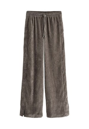 Grå, vida byxor med dragkedja i midjan, tillverkade av mjukt, texturerat tyg. Har sidofickor i botten för extra stil.