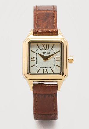 Neliönmuotoinen Timex-kellon runko kultaisella sävyllä, hopeanvärinen kellotaulu, mustat roomalaiset numerot, mustat osoittimet ja ruskea nahkaranneke ompeleilla.