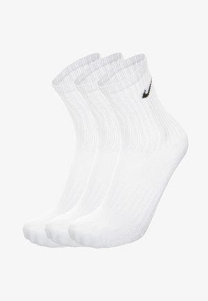 Calzini bianchi in cotone con texture a coste, dotati di logo Nike nero. La confezione include tre paia, design alla caviglia.