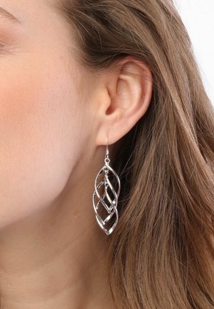 Zilveren metalen oorbellen met een golvende bladvorm. De oorbellen zijn verlengd en hangen onder de oorlellen, met een gepolijste afwerking.