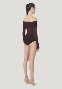 Off-shoulder bodystocking i dyb burgunder med rynket design, lange ærmer og en tætsiddende bund, kombineret med nøgne høje hæle.