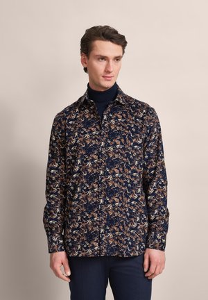 Navy button-up shirt featuring a floral pattern in browns and creams, made of lightweight fabric, with a classic collar and long sleeves.