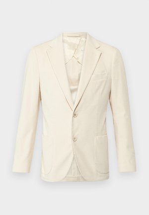 Blazer beige in tessuto texturizzato, design a un bottone, due tasche frontali e revers a scendere. Interno foderato con leggera lucentezza.