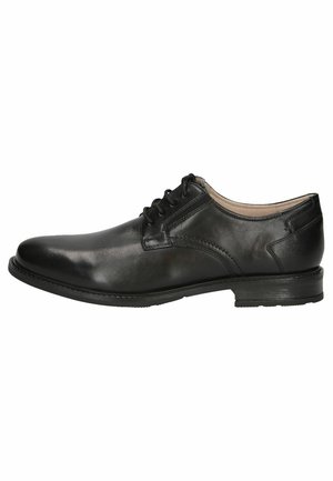 Chaussure habillée en cuir noir avec une texture lisse, bout rond et design à lacets. Elle présente un petit talon et un subtil détail de couture sur le côté.