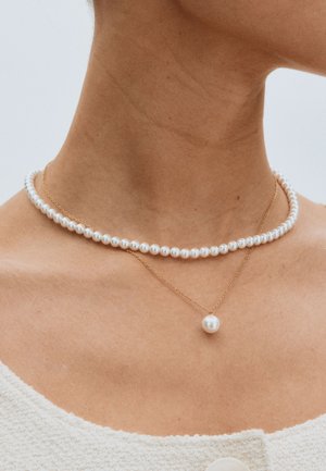 Pearl necklace layered with a gold chain featuring a single pearl pendant; smooth, round pearls in white, delicate gold hardware.