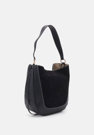 Black handbag with suede and leather materials, curved shape, stitched accents, and a shoulder strap. Open top design with a spacious interior.