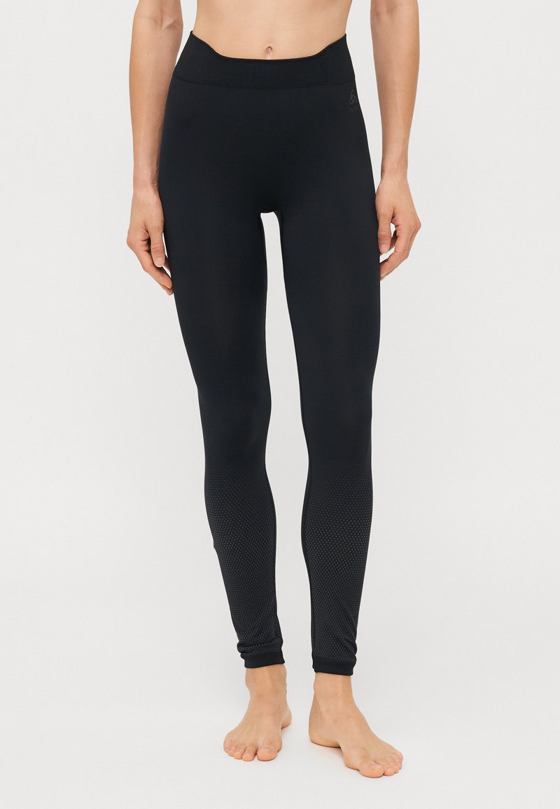 Black athletic leggings featuring a high waistband, smooth fabric texture, and a patterned mesh inset at the lower leg.