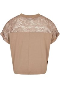 Kort beige top med blonderyg og korte ærmer, i en afslappet pasform med diskrete stikninger langs kanten.