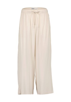 Culottes beige clair, hauteur genoux, en tissu doux avec une taille élastique et un cordon de serrage. Comprend des poches latérales et une coupe décontractée.