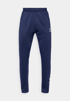 Navy blue athletic pants with an elastic waistband, tapered legs, and white stripes along the side. Made from a smooth, stretchy material.