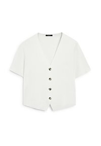 Haut blanc à manches courtes avec un col en V et cinq boutons ronds noirs sur le devant. Matière lisse avec une coupe décontractée et un design court.