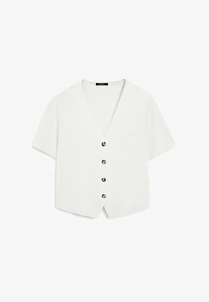 Hvid kortærmet top med V-hals og fem runde sorte knapper ned foran. Glat materiale med en afslappet pasform og cropped design.