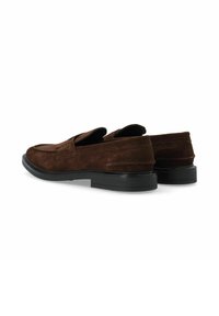 Mocasines de ante marrón con puntera redondeada, detalles de costura sutiles y una suela de goma negra para mayor tracción.