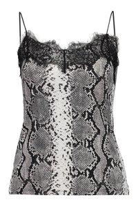 Svart och vit ormtryckt linne med spetskant, med justerbara remmar och en figurnära silhuett. Texturerad tyg med unika mönster.
