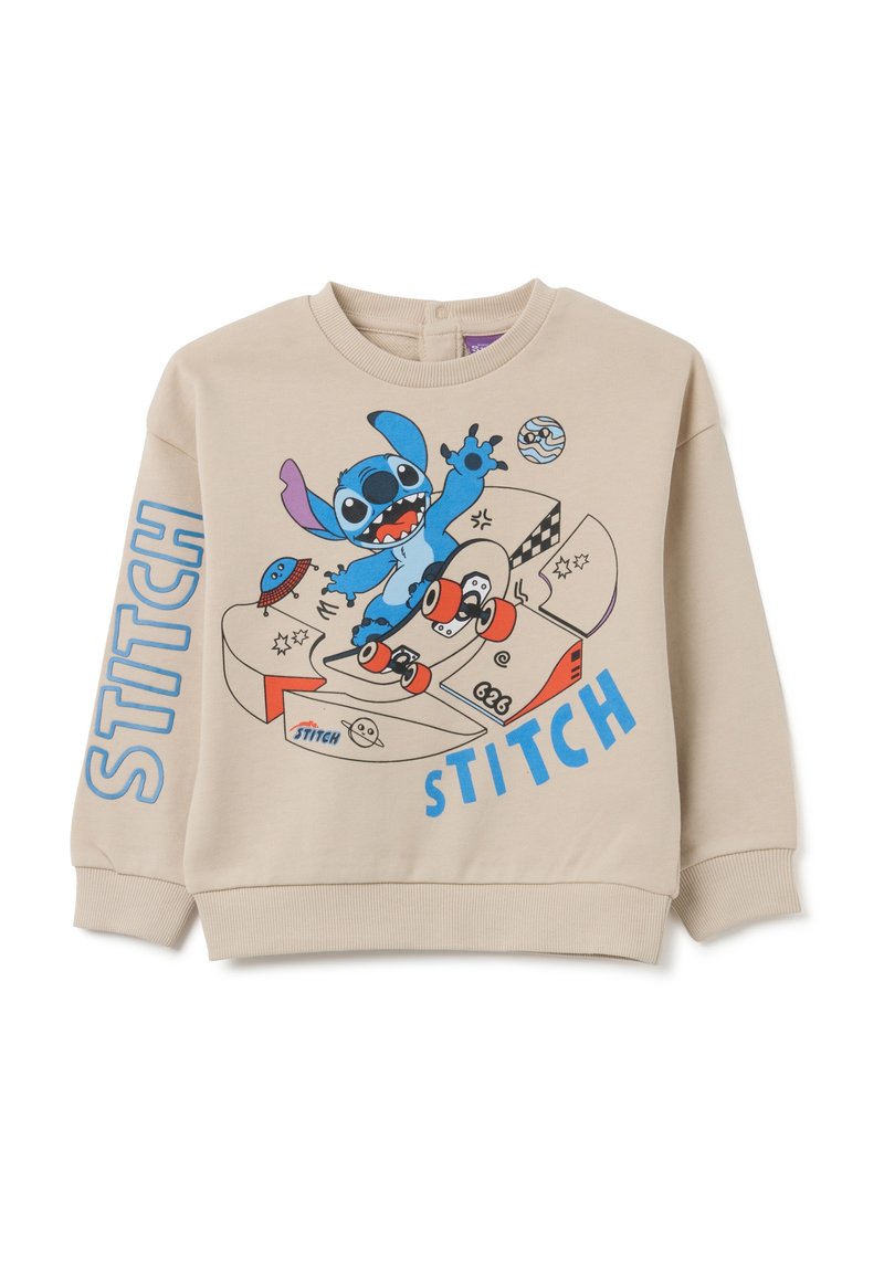 Felpa beige con un design a cartone colorato raffigurante un personaggio alieno blu che fa skate, con la scritta "STITCH" stampata in lettere blu in grassetto.