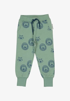 Lys grønne sweatpants med et gentaget mønster af marineblå løveansigt, elastisk talje med snøre og afsluttede ankler. Blødt bomuldsstof.