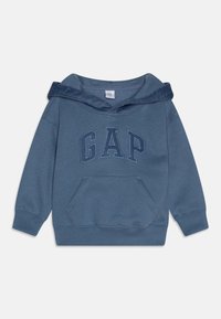 Sweat à capuche bleu doux, avec une capuche côtelée, une grande poche kangourou et le logo « GAP » en tissu texturé. Manches longues avec poignets côtelés.