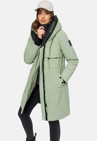 Long, light green puffer coat with black accents, a high collar, double-breasted front, and detailed stitching. Features multiple pockets.