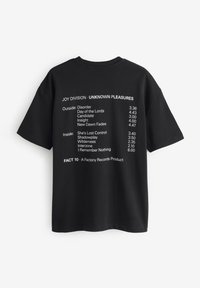 Black cotton t-shirt featuring white printed text. Back design lists Joy Division album tracks and timings, with "FACT 10" at the bottom.