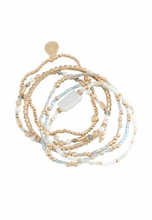 Multi-strand bracelet with gold, white, blue beads, and a rectangular white stone charm on a white background.