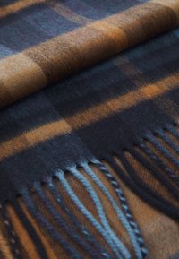 Wollschal mit einem karierten Muster in Dunkelblau, Orange und Braun, mit Fransenkanten; glatte Textur und subtile Farbvariationen.