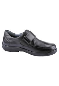 Scarpa in pelle nera con punta rotonda, dettagli cuciti e cinturino regolabile. Suola in gomma testurizzata per una buona presa e comfort.