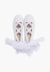 White ballet shoes with crossed straps and a soft, tulle accent at the back. The shoes are displayed from a top-down perspective.