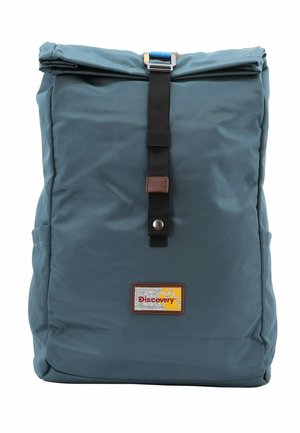 Blue fabric backpack with a roll-top design, secured by a black strap and buckle. Features a brown leather label with the word "Discovery."