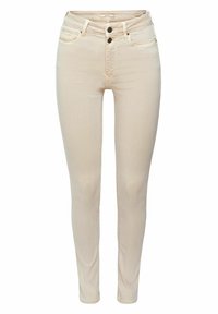 Jean slim beige avec deux boutons noirs, poches avant, passants de ceinture et fermeture éclair devant, vue de face sur un fond uni.