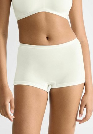 Light cream cotton boyshorts with a smooth texture, mid-rise waist, and minimal seams, paired with a matching crop top.