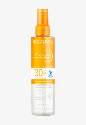 Bioderma Photoderm Eau Solaire Bronz SPF 30 spray hydratant pour peau sensible, favorise le bronzage, flacon de 200 ml avec bouchon orange.
