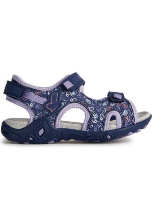 Sandalias moradas y navy con patrón floral, correas ajustables de velcro, diseño abierto en la punta y suela de goma texturizada con acentos de agarre.