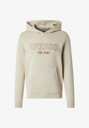 Sudadera con capucha beige con bolsillo frontal, capucha con cordón y bordado "GUESS EST. 1981" en hilo marrón. Tejido suave y puños acanalados.
