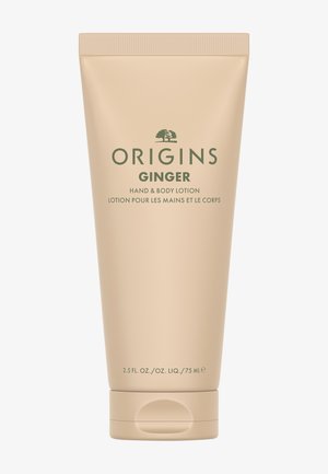 Origins Ginger Hand- und Körperlotion in einer beigen 75 ml drückbaren Tube mit grünem Text und Klappdeckel.
