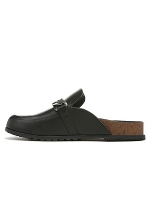 Black leather slip-on clogs with a cork insole, featuring a decorative metal buckle and textured rubber sole for grip.