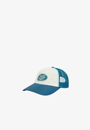 Gorra de béisbol con visera azul, panel frontal blanco, malla azul en la parte trasera y parche ovalado con la inscripción "Scalpers La Residence Paris" en el frente.