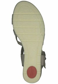 Helle beige Sandalensohle mit einer strukturierten weißen Gummibasis. Verfügt über eine rote kreisförmige Verzierung mit der Aufschrift "Komfort." Größe 37 ist auf der Sohle markiert.