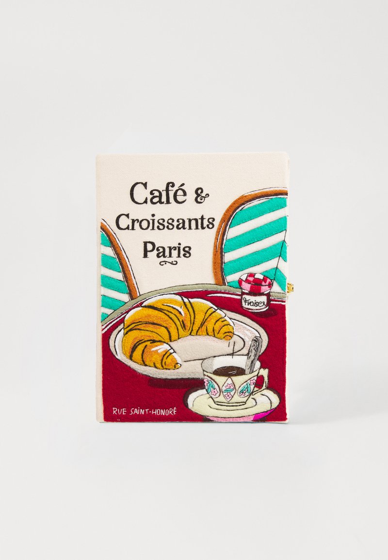 Copertura per quaderno in tela ricamata che raffigura un croissant su un piatto e una tazza di caffè, con accenti colorati e il testo "Café & Croissants Paris."