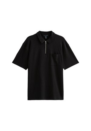 Zwarte polo shirt van katoenmix, met een halve rits aan de voorkant, korte mouwen en een borstzak aan de linkerkant. Glad textuur, ontspannen pasvorm.